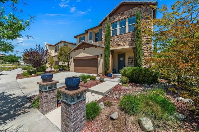 view of front of home with stone siding, stucco siding, and a garage
