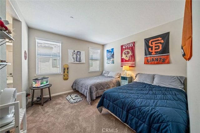 bedroom featuring carpet and baseboards