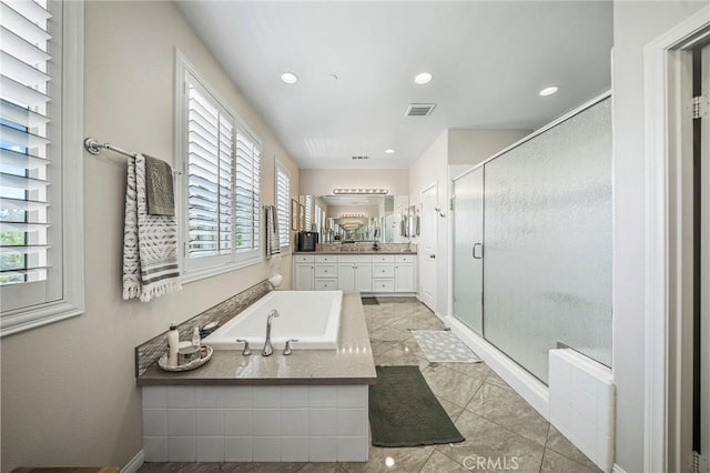 bathroom with a garden tub, a shower stall, vanity, and recessed lighting