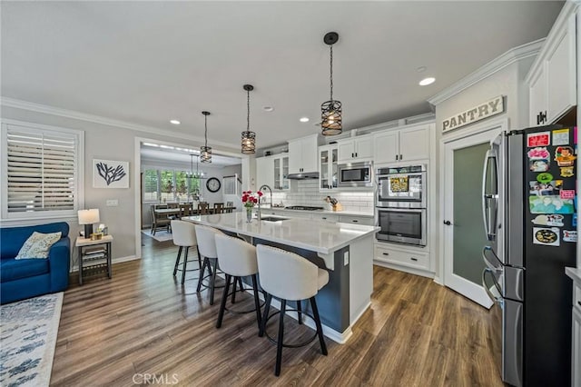 kitchen with stainless steel appliances, recessed lighting, dark wood finished floors, white cabinetry, and light countertops