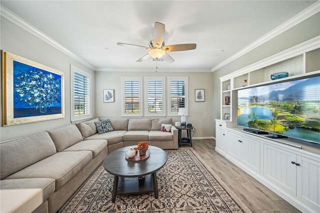 living room with light wood-style flooring, ornamental molding, ceiling fan, and baseboards