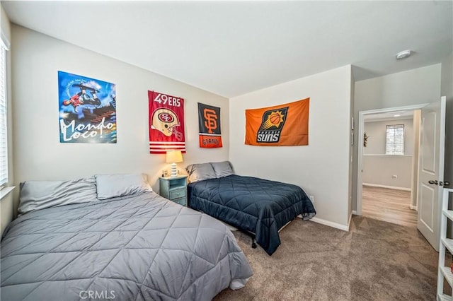bedroom with baseboards and carpet flooring