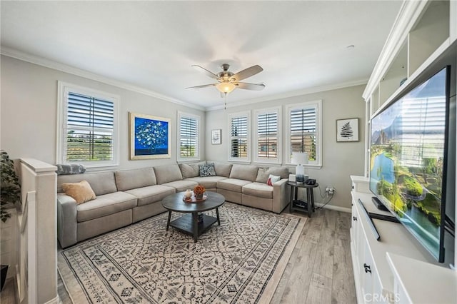 living area with ceiling fan, crown molding, light wood-style floors, and baseboards