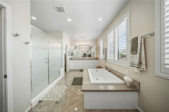 full bath with a stall shower, vanity, a garden tub, recessed lighting, and tile patterned floors