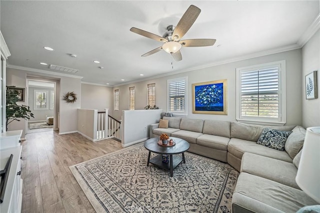 living room with plenty of natural light, recessed lighting, light wood-style flooring, crown molding, and a ceiling fan
