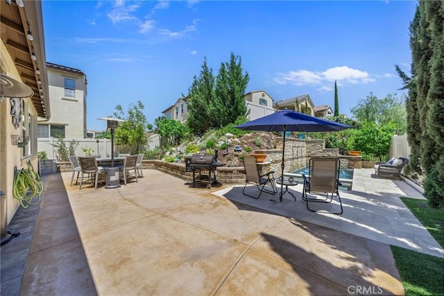 view of patio featuring outdoor dining area, grilling area, and fence