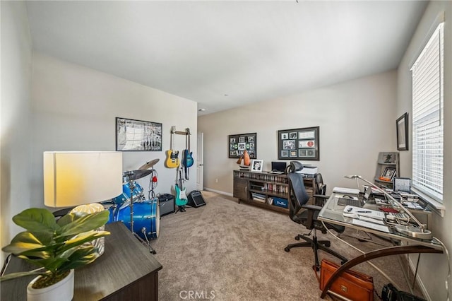 carpeted office space featuring baseboards