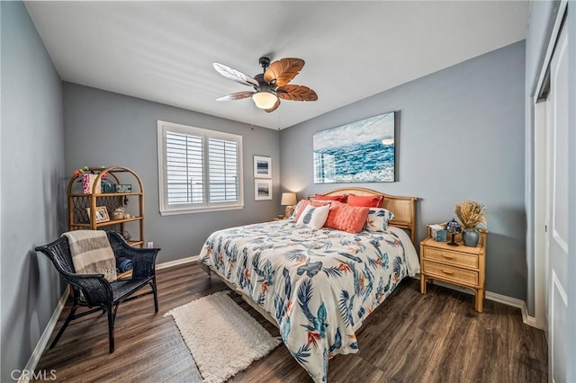 bedroom with baseboards, dark wood-type flooring, and a ceiling fan