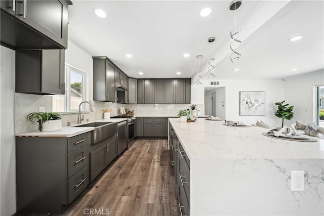 22713 Islamare, Lake Forest, CA 92630 - kitchen featuring a sink, gas range oven, plenty of natural light, light stone counters, and recessed lighting