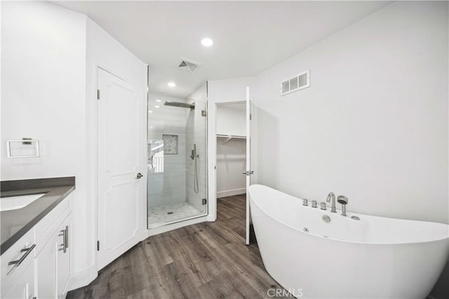 22713 Islamare, Lake Forest, CA 92630 - full bathroom featuring wood finished floors, a shower stall, a freestanding tub, vanity, and recessed lighting