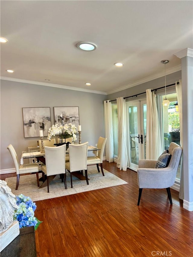 dining space with dark wood finished floors, baseboards, crown molding, french doors, and recessed lighting
