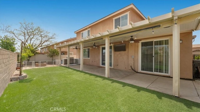 back of house with a ceiling fan, stucco siding, and a patio
