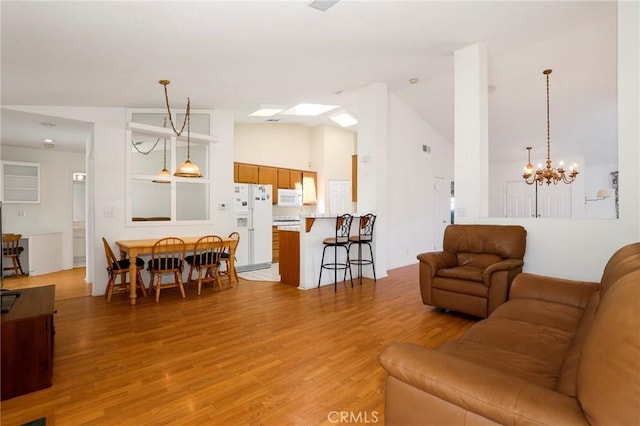 4102 Victoria Ln, Quartz Hill, CA 93536 - living area featuring light wood-style flooring, a chandelier, and high vaulted ceiling