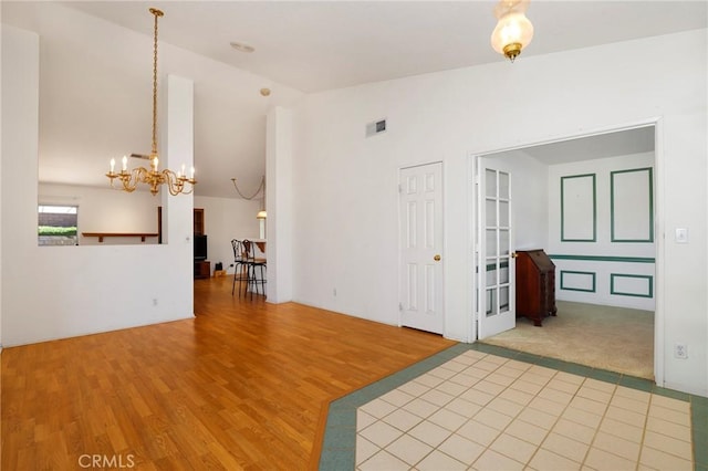 4102 Victoria Ln, Quartz Hill, CA 93536 - empty room featuring lofted ceiling, a chandelier, and wood finished floors