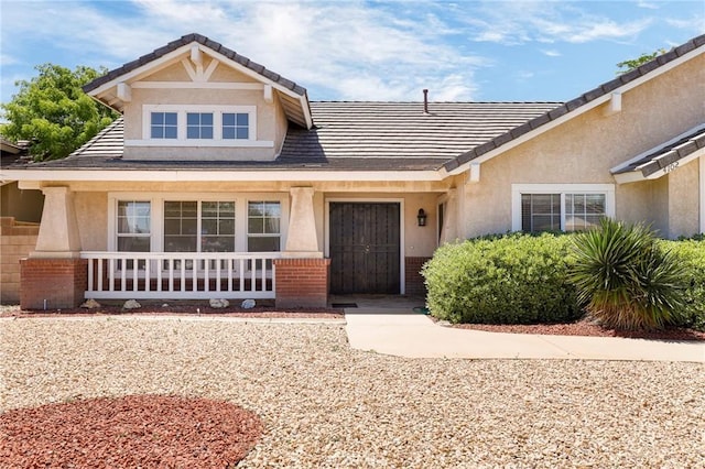 4102 Victoria Ln, Quartz Hill, CA 93536 - view of front of property with stucco siding, brick siding, a tile roof, and covered porch