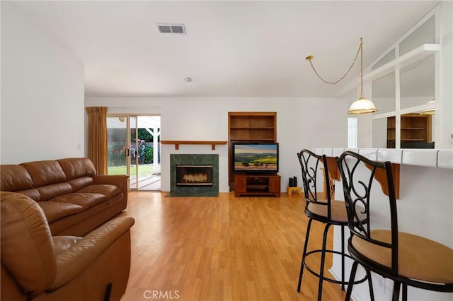 4102 Victoria Ln, Quartz Hill, CA 93536 - living area featuring light wood finished floors, a fireplace, and built in features