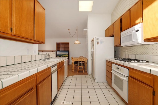 4102 Victoria Ln, Quartz Hill, CA 93536 - kitchen featuring white appliances, backsplash, tile counters, and brown cabinetry