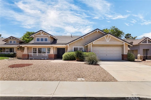 4102 Victoria Ln, Quartz Hill, CA 93536 - view of front of house featuring an attached garage, concrete driveway, brick siding, and stucco siding