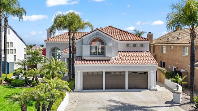 23721 Via Segovia, Murrieta, CA 92562 - mediterranean / spanish-style home featuring concrete driveway, stucco siding, a garage, and a tile roof