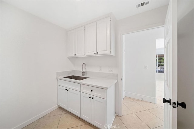 23721 Via Segovia, Murrieta, CA 92562 - clothes washing area with a sink, baseboards, and light tile patterned floors