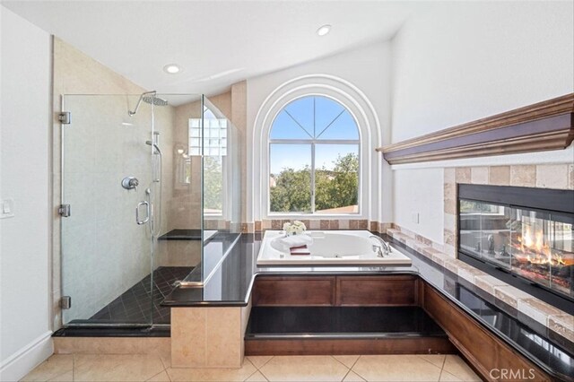 23721 Via Segovia, Murrieta, CA 92562 - full bathroom featuring tile patterned flooring, a stall shower, a jetted tub, recessed lighting, and a multi sided fireplace