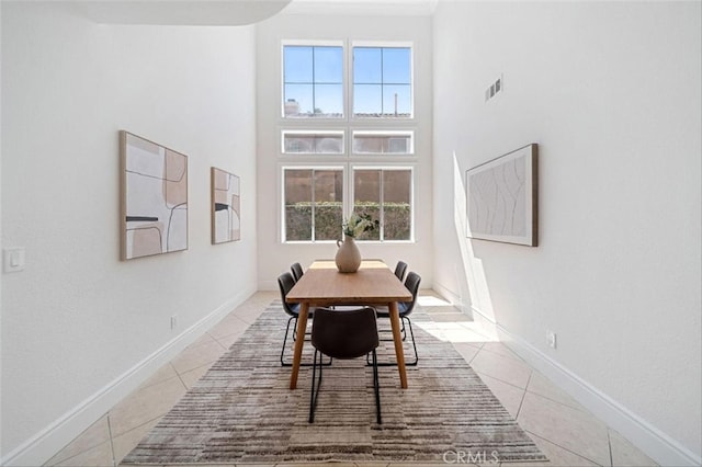 23721 Via Segovia, Murrieta, CA 92562 - dining space with light tile patterned flooring, a towering ceiling, and baseboards
