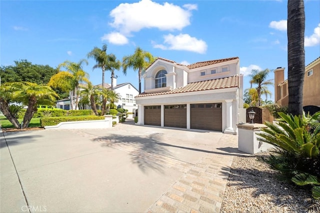 23721 Via Segovia, Murrieta, CA 92562 - mediterranean / spanish house featuring a tile roof, a garage, driveway, and stucco siding