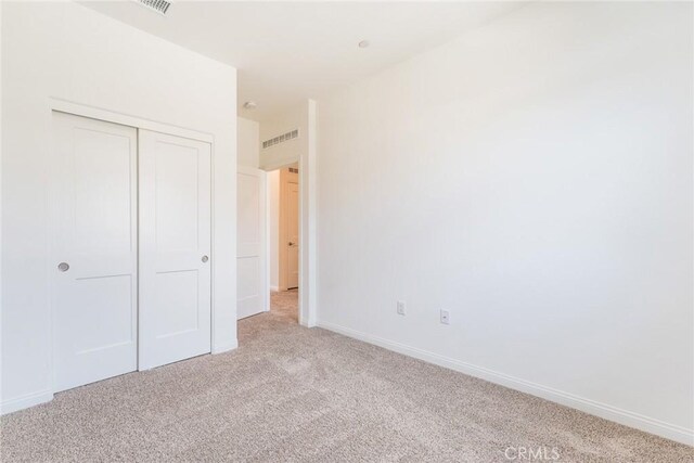 1609 Fig Tree Way, Oceanside, CA 92056 - unfurnished bedroom with light colored carpet, a closet, and baseboards