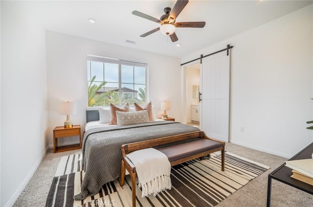 1609 Fig Tree Way, Oceanside, CA 92056 - bedroom featuring a barn door, light carpet, baseboards, a ceiling fan, and connected bathroom