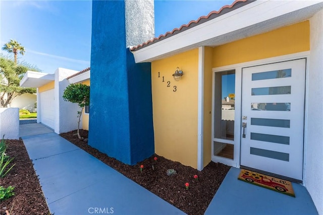 1123 E El Cid E, El Cid, Palm Springs, CA 92262 - entrance to property featuring a tiled roof and stucco siding