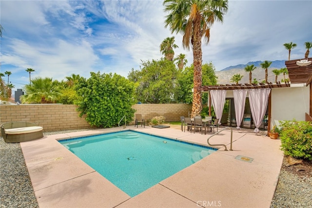 1123 E El Cid E, El Cid, Palm Springs, CA 92262 - view of pool with a patio area, a fenced backyard, and a mountain view