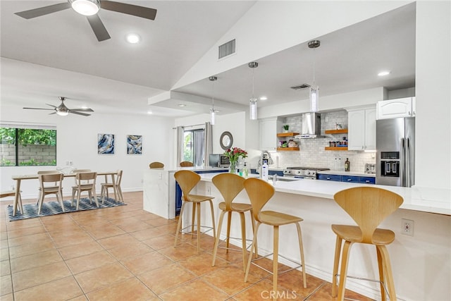1123 E El Cid E, El Cid, Palm Springs, CA 92262 - kitchen featuring stainless steel fridge, a ceiling fan, a sink, open shelves, and wall chimney exhaust hood