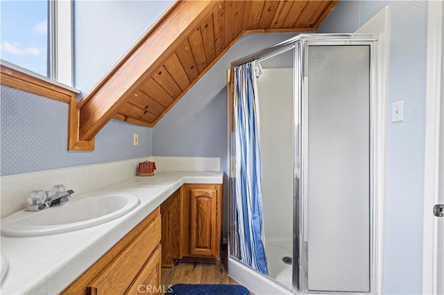 1513 Bernina Dr, Pine Mountain Club, CA 93222 - full bathroom with lofted ceiling, a stall shower, vanity, wood finished floors, and wallpapered walls