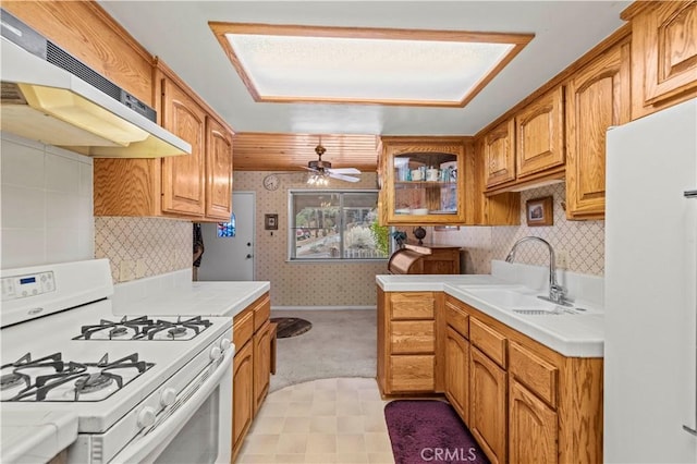 1513 Bernina Dr, Pine Mountain Club, CA 93222 - kitchen featuring white appliances, under cabinet range hood, a sink, wallpapered walls, and tile counters