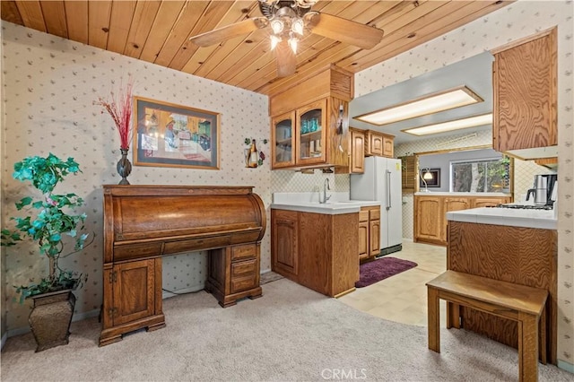 1513 Bernina Dr, Pine Mountain Club, CA 93222 - kitchen featuring wallpapered walls, freestanding refrigerator, ceiling fan, glass insert cabinets, and light countertops