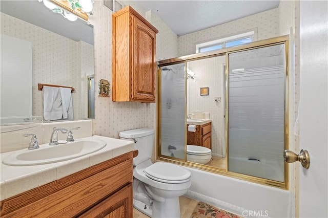 1513 Bernina Dr, Pine Mountain Club, CA 93222 - full bath featuring wallpapered walls, toilet, vanity, and combined bath / shower with glass door
