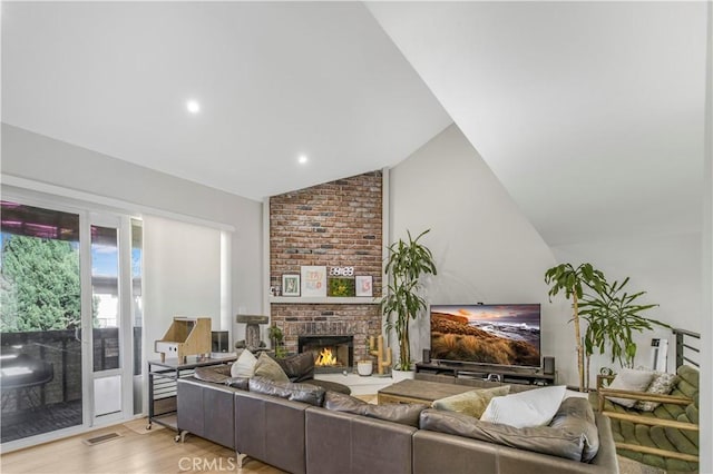 9321 Chapman Ave Unit 2, Garden Grove, CA 92841 - living area featuring vaulted ceiling, light wood finished floors, and a brick fireplace
