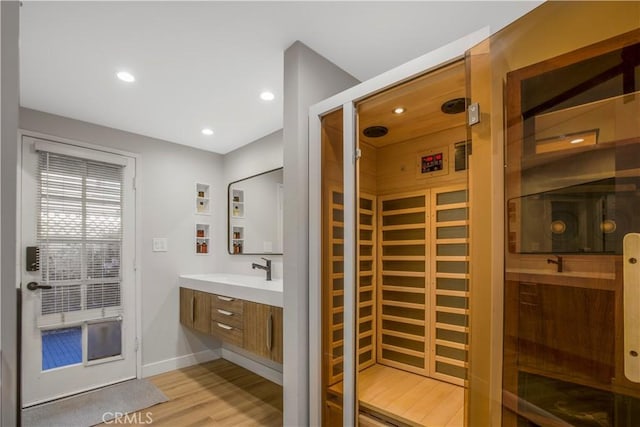 9321 Chapman Ave Unit 2, Garden Grove, CA 92841 - bathroom with wood finished floors, vanity, baseboards, and recessed lighting