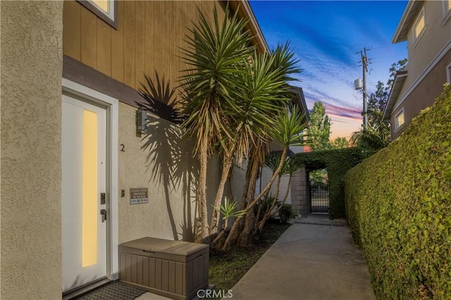9321 Chapman Ave Unit 2, Garden Grove, CA 92841 - exterior entry at dusk with stucco siding and a gate