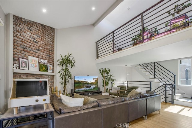 9321 Chapman Ave Unit 2, Garden Grove, CA 92841 - living room featuring stairway, wood finished floors, a high ceiling, recessed lighting, and a fireplace