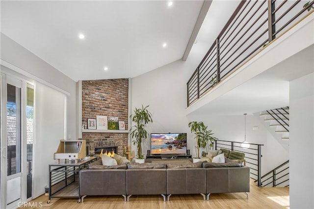 9321 Chapman Ave Unit 2, Garden Grove, CA 92841 - living room with a fireplace, light wood-style flooring, stairs, and recessed lighting