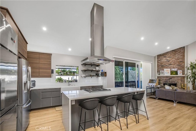 9321 Chapman Ave Unit 2, Garden Grove, CA 92841 - kitchen with island range hood, lofted ceiling, stainless steel refrigerator with ice dispenser, modern cabinets, and a kitchen bar