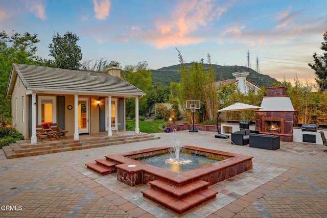 181 Via Sandra, Newbury Park, CA 91320 - view of patio featuring a warm lit fireplace, a grill, and a mountain view