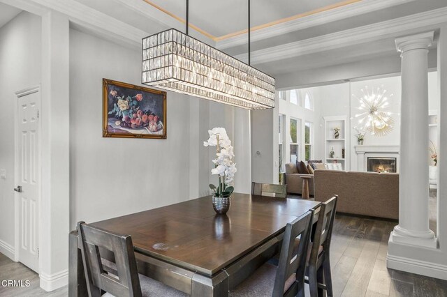 181 Via Sandra, Newbury Park, CA 91320 - dining space with ornate columns, wood-type flooring, crown molding, a glass covered fireplace, and built in features