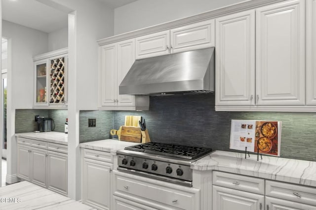 181 Via Sandra, Newbury Park, CA 91320 - kitchen with under cabinet range hood, stainless steel gas cooktop, white cabinets, backsplash, and glass insert cabinets