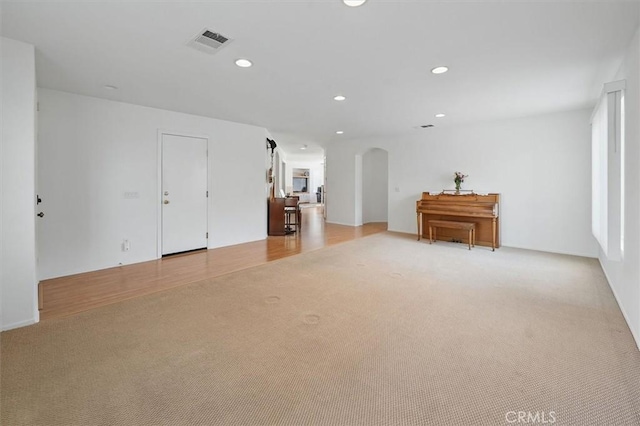 28652 Deer Springs Dr, Saugus, CA 91390 - spare room with light carpet, arched walkways, and recessed lighting