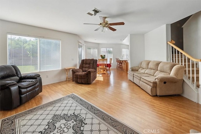 28652 Deer Springs Dr, Saugus, CA 91390 - living room with wood finished floors, a ceiling fan, and stairs