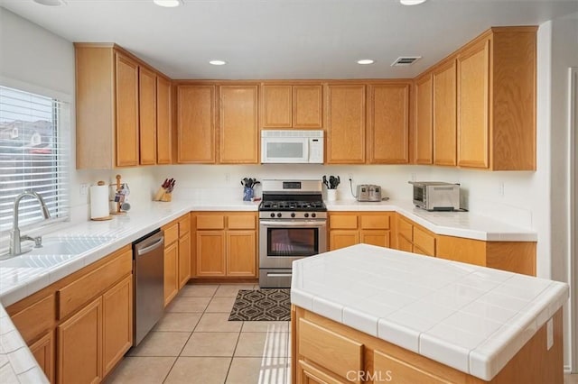 28652 Deer Springs Dr, Saugus, CA 91390 - kitchen with stainless steel appliances, a sink, recessed lighting, and light tile patterned flooring
