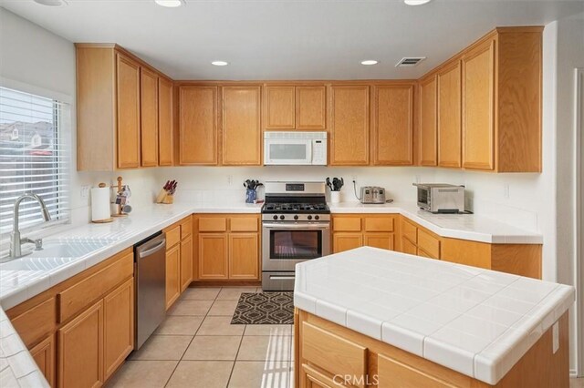 28652 Deer Springs Dr, Saugus, CA 91390 - kitchen featuring stainless steel appliances, recessed lighting, and light tile patterned floors