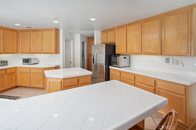 28652 Deer Springs Dr, Saugus, CA 91390 - kitchen featuring stainless steel appliances, a center island, light tile patterned floors, recessed lighting, and tile countertops